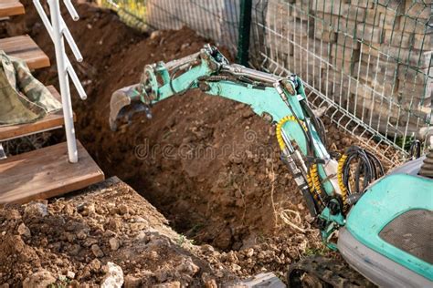 mini excavator well|digging a trench for a well.